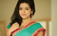 Tollywood actress Iswarya Menon in red and green mix saree.