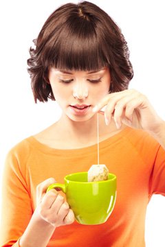 young-woman-making-a-cup-of-green-tea young-woman-making-a-cup-of-green-tea